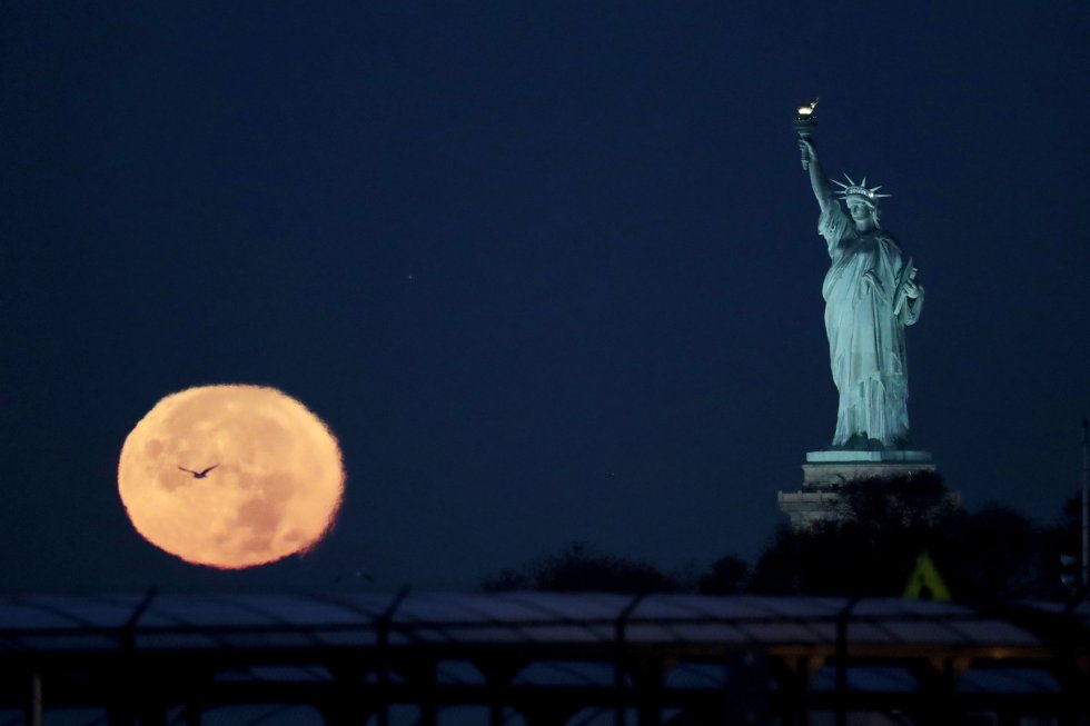 La Superluna junto a la Estatua de la Libertad, en Nueva York (Estados Unidos)